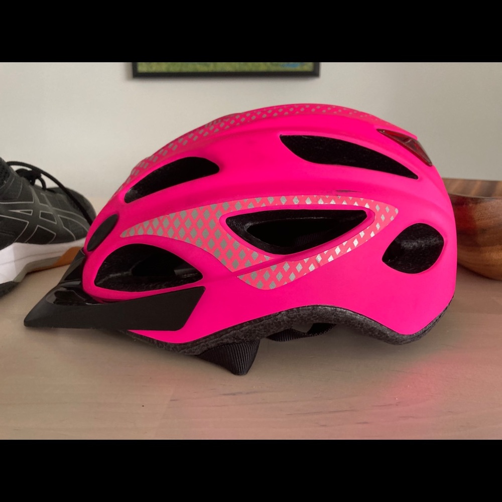 Bright pink Schwinn bicycle helmet with lights